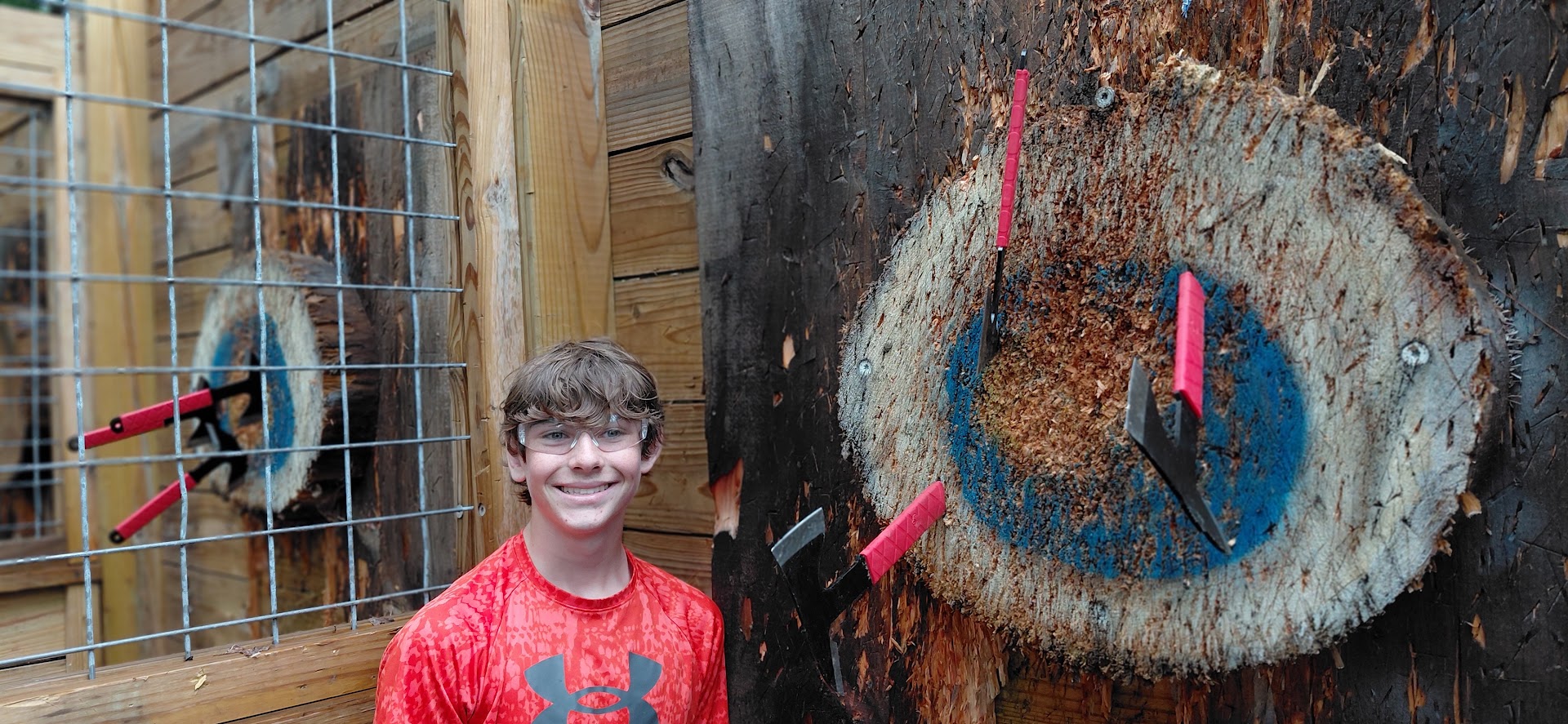 Scout practicing axe throwing at Yawgoog.